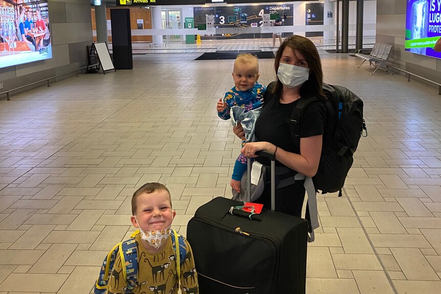 Anna Davey with her children at an airport.