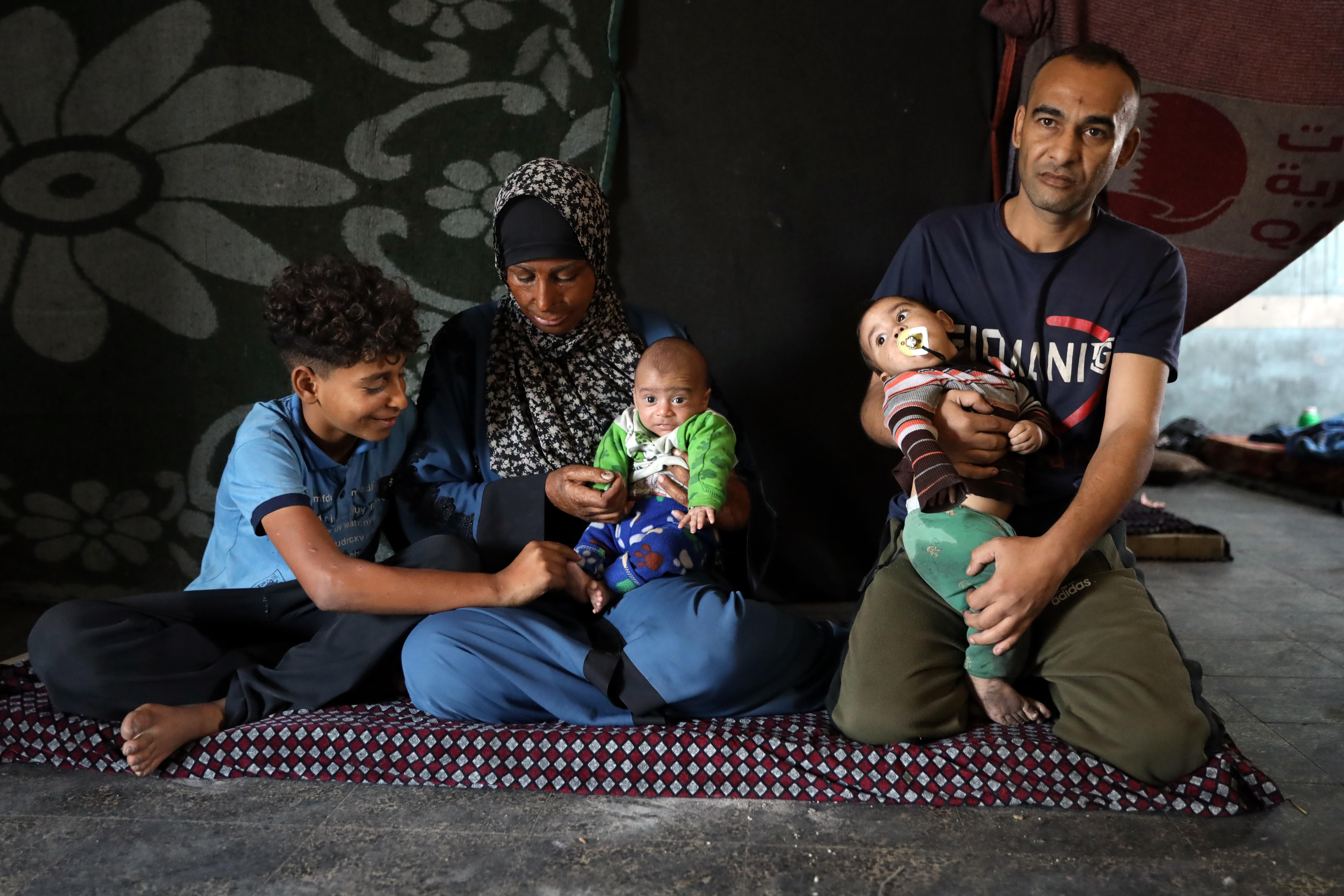 A man, woman, two babies and a young boy.