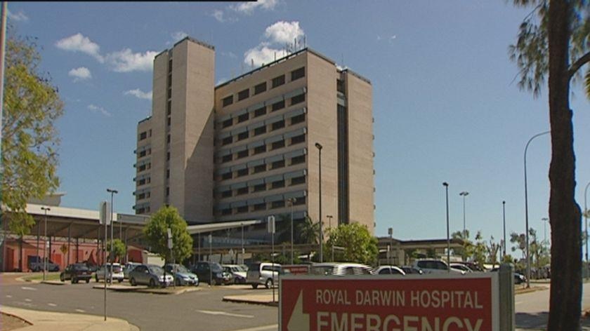 Royal Darwin Hospital stands behind a sign for the emergency department