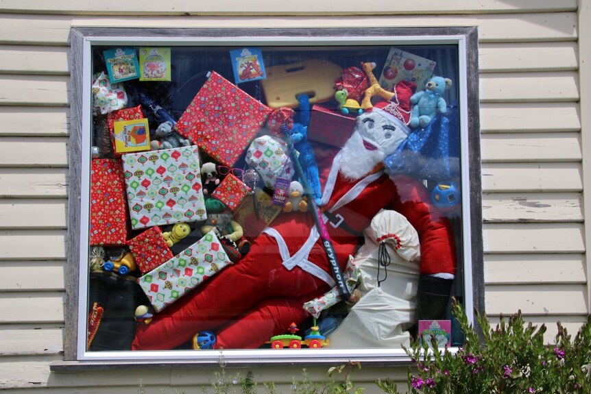 A stuffed Santa forms part of a window display in the northern Tasmanian town of Lilydale