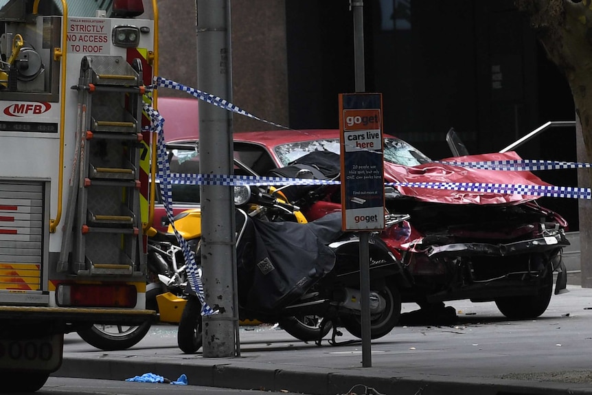 A car is seen crushed and damaged after being driven through busy Bourke St mall.