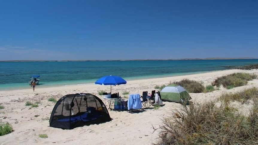 a white beach with tents