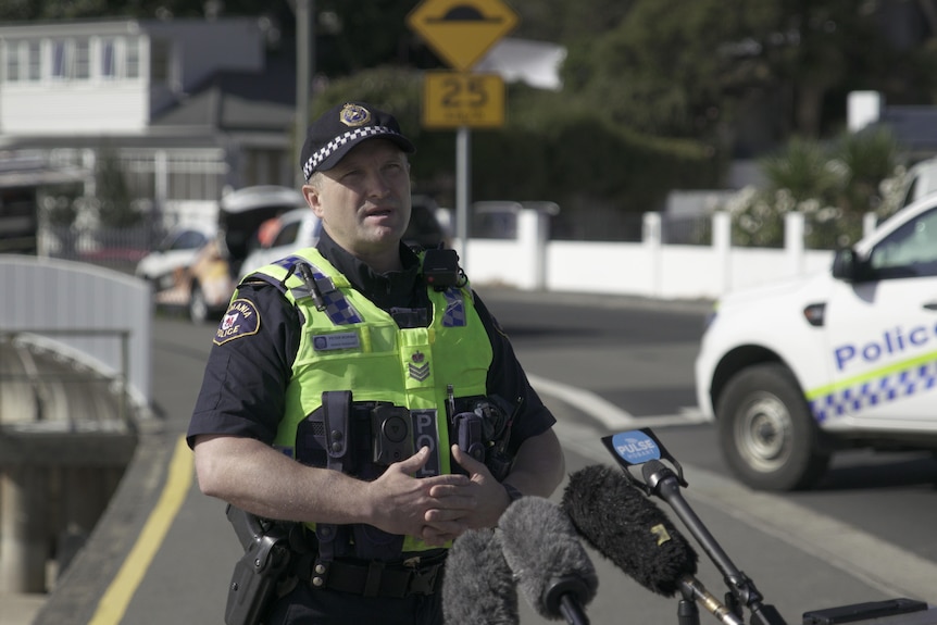 Policeman in high vis stands on a street 