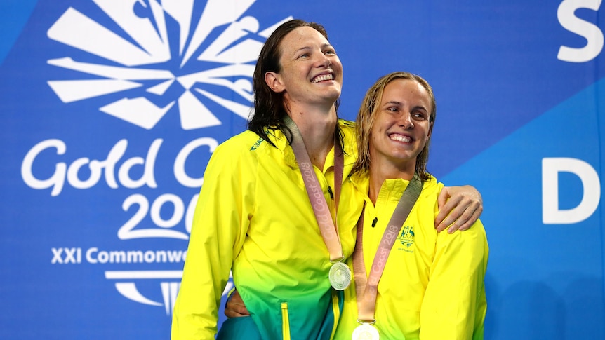 Cate Campbell hugs Bronte Campbell. They each have a medal around their neck.