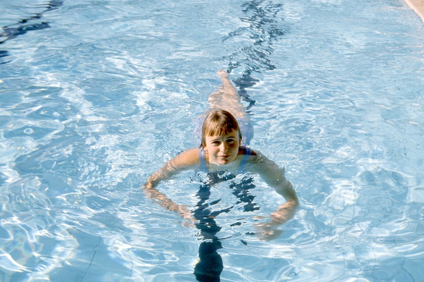 Paralympian Elizabeth Edmondson, as a teenager, swims in a pool.