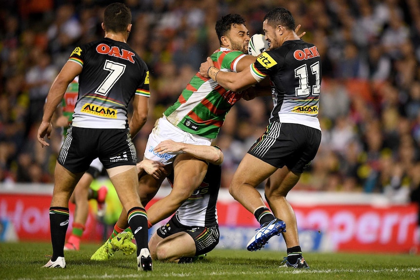 Zane Musgrove of the Rabbitohs is tackled by Corey Harawira-Naera of the Panthers during the round six NRL match in Penrith on April 7, 2017