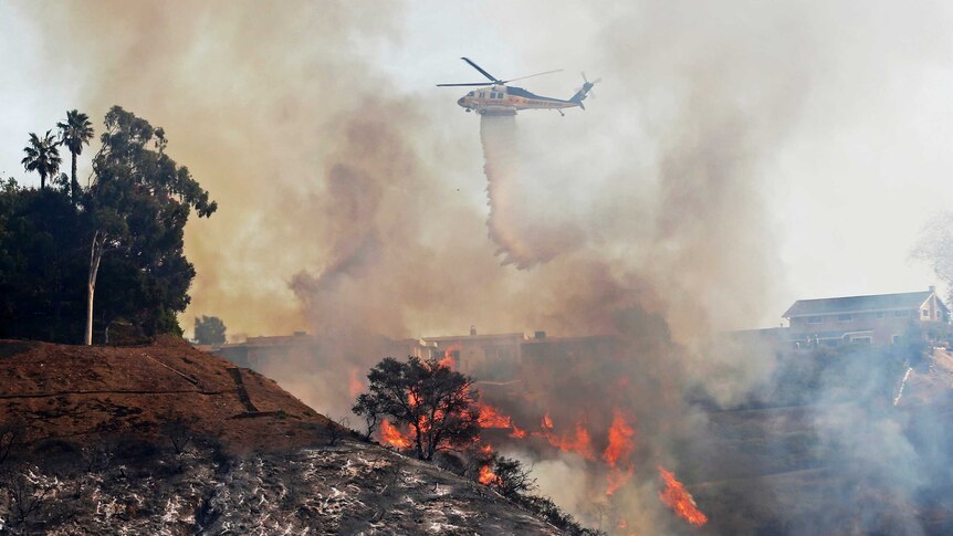 Fire department helicopter drops water on the California wildfires