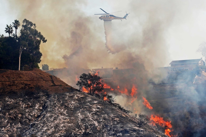 Fire department helicopter drops water on the California wildfires