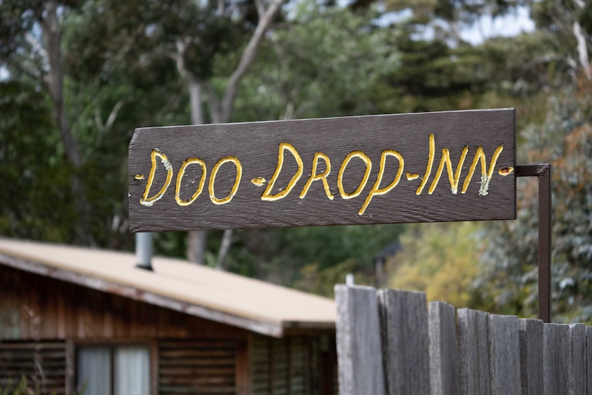 Picture of a sign that says 'Doo Drop Inn'