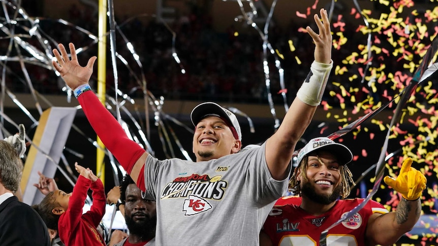 Patrick Mahomes raises his hands in the air as streamers fall after the Kansas City Chiefs' Super Bowl LIV win.