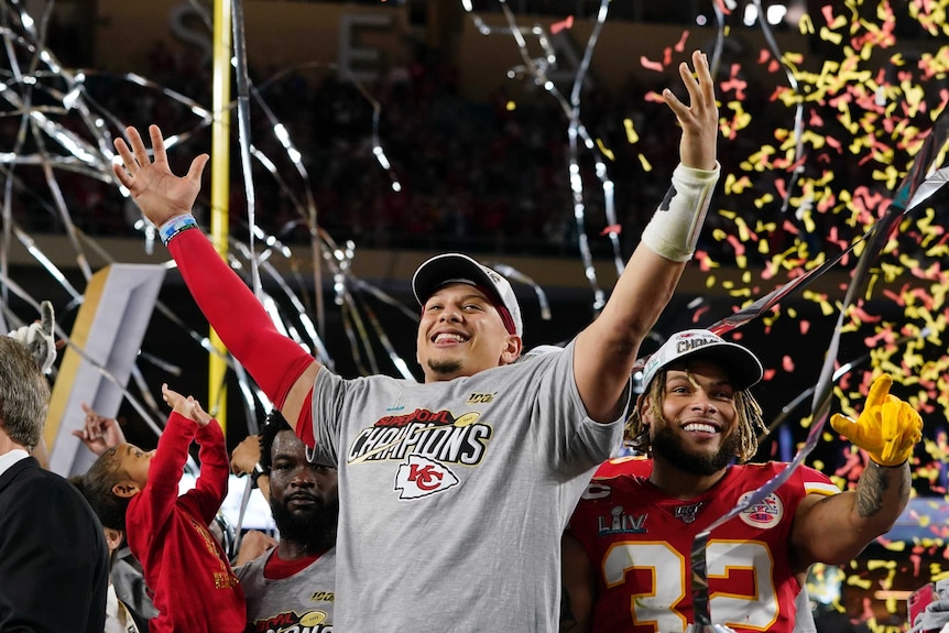 Patrick Mahomes raises his hands in the air as streamers fall after the Kansas City Chiefs' Super Bowl LIV win.