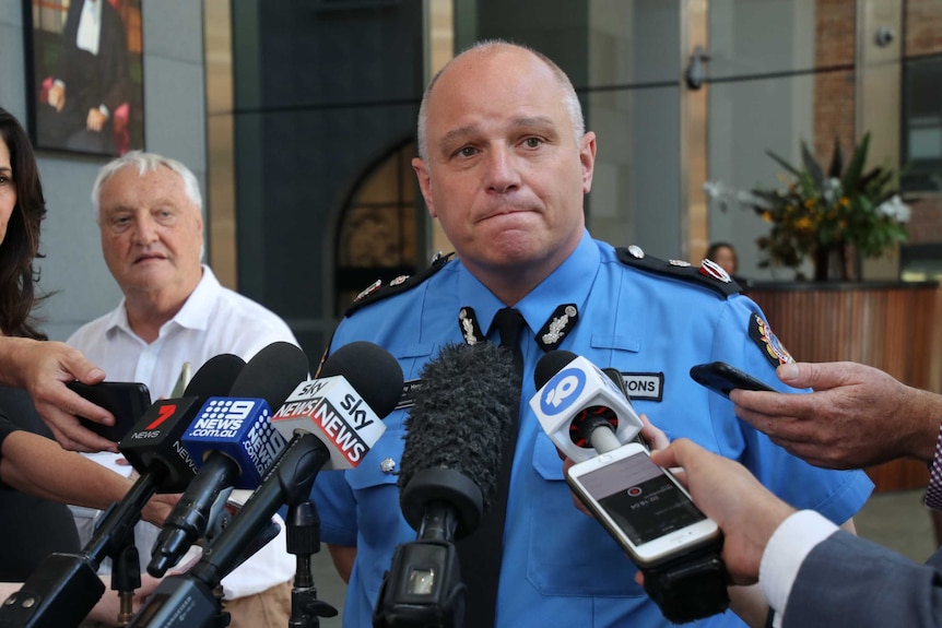 A mid shot of WA's Corrective Services Commissioner Tony Hassall speaking to the media with microphones in front of him.