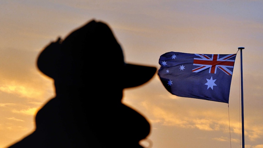 The shadow of an Australian veteran with an Australian flag in the background