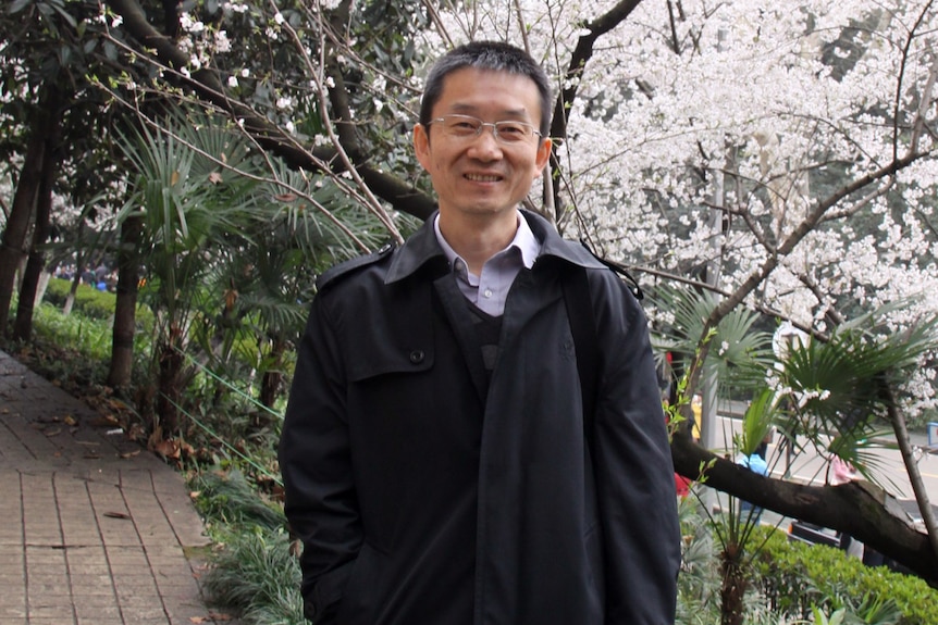 George Liu standing in a garden. 