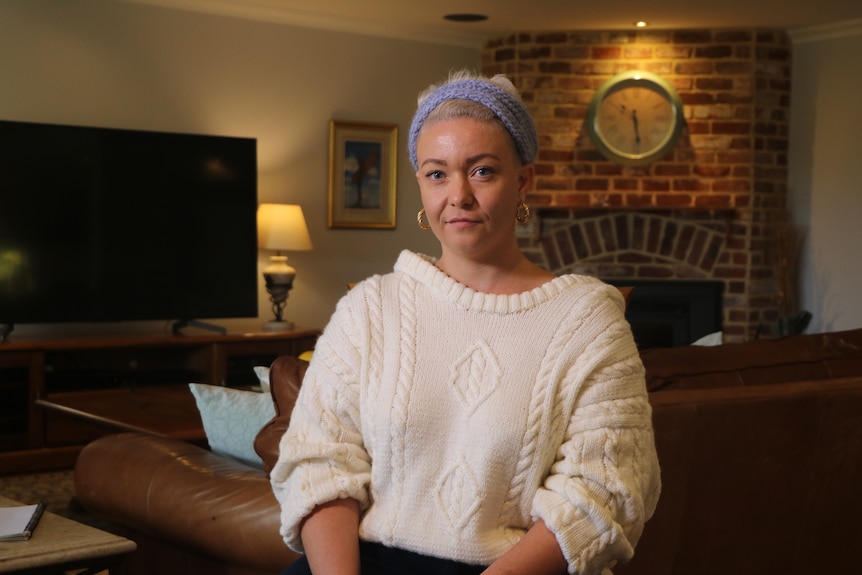 Ashleigh Telford sitting in parents' living room.