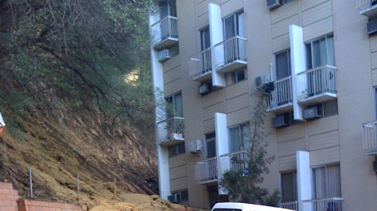 Landslide outside a block of apartments which had to be evacuated after the storm swept through in P