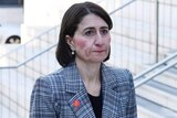 Gladys Berejiklian stands on staircase outside