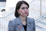 Gladys Berejiklian stands on staircase outside