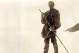 old black and white photo of man on skis 