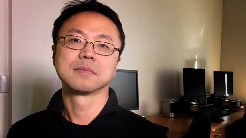 Associate professor Jae Jung standing in front of computers at UNSW Kensington Campus.