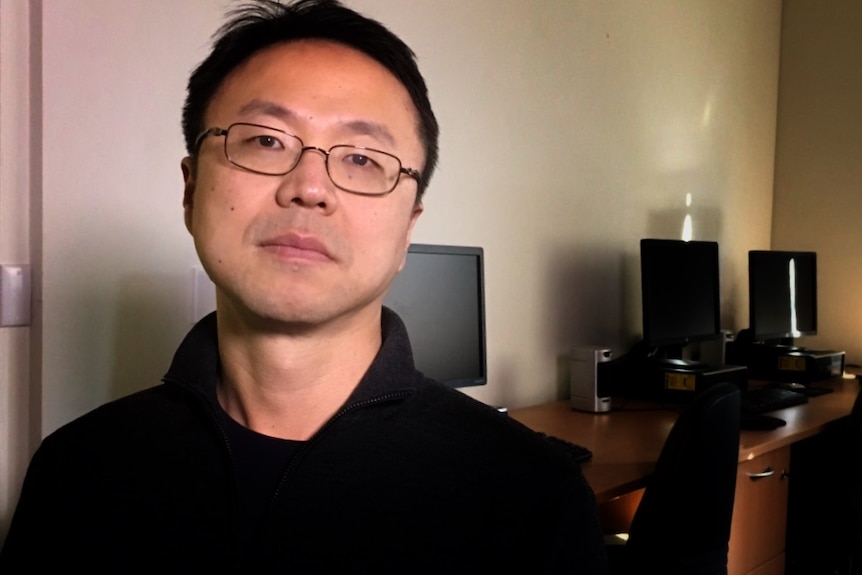 Associate professor Jae Jung standing in front of computers at UNSW Kensington Campus.