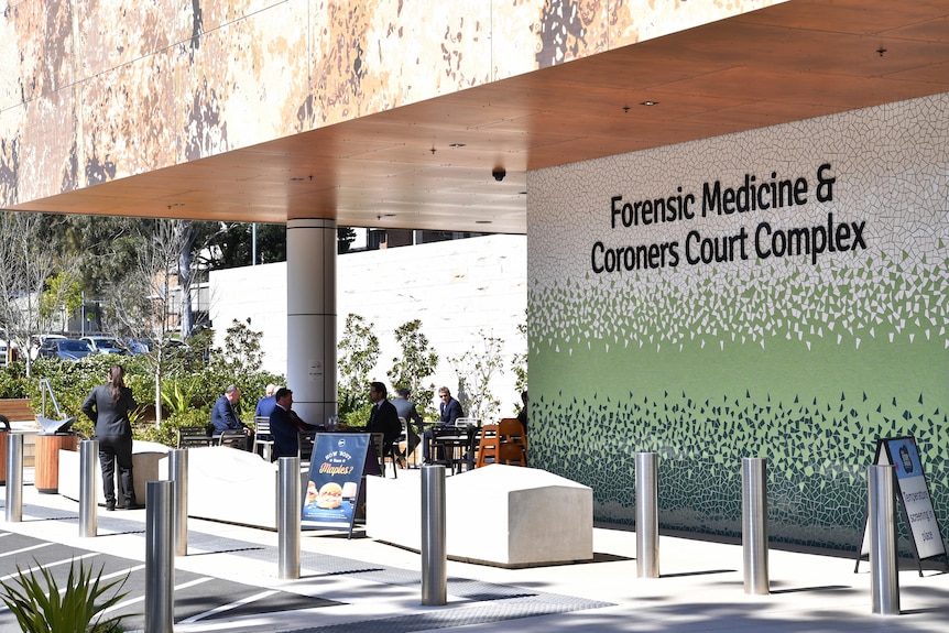 The exterior of a modern-looking building with lettering that reads "Forensic Medicine and Coroners Court Complex".