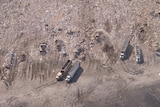 Aerial shot of landfill and trucks