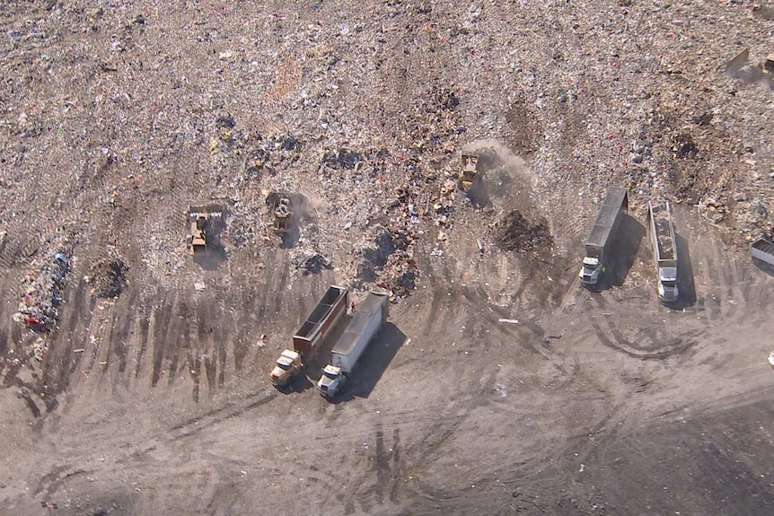 Aerial shot of landfill and trucks