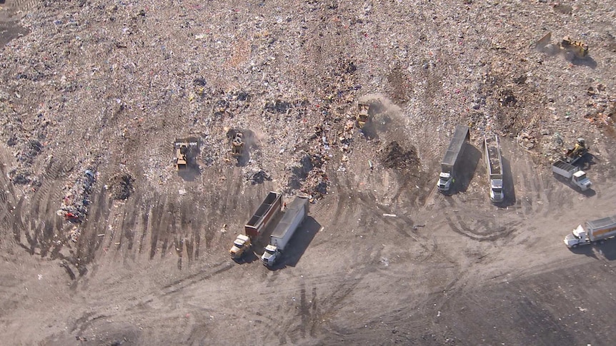 Aerial shot of landfill and trucks