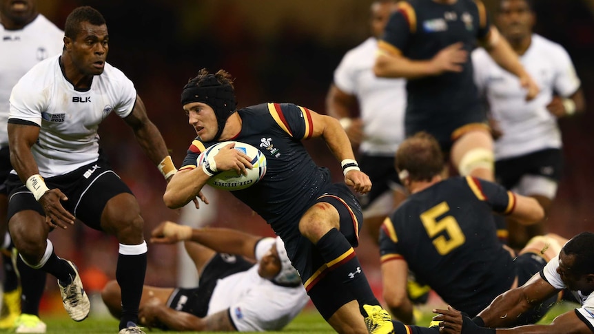 Wales' Matthew Morgan bursts through Fiji defence