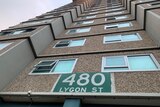 A ground view close to the public housing tower, looking up, with a '480 Lygon St' sign visible.