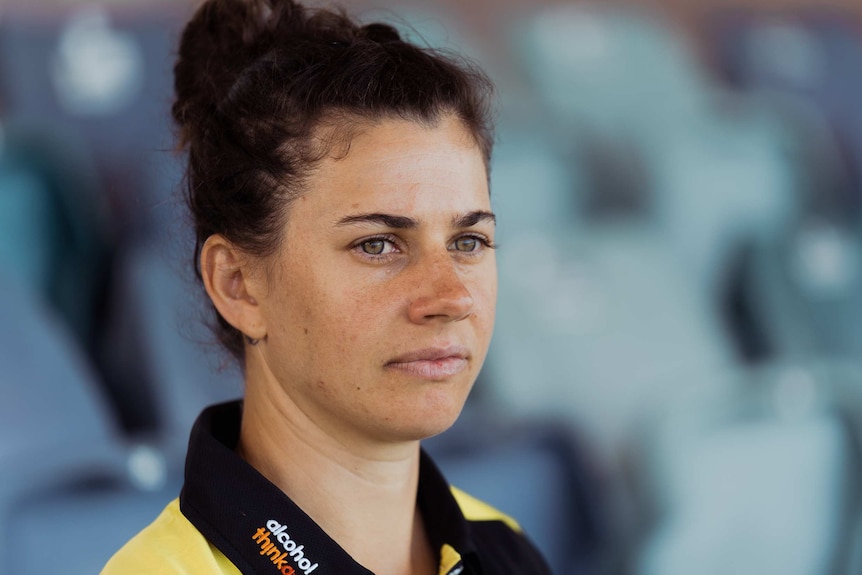 West Australian Cricketer Nicole Bolton sits in the stands. She's looking into the middle distance.