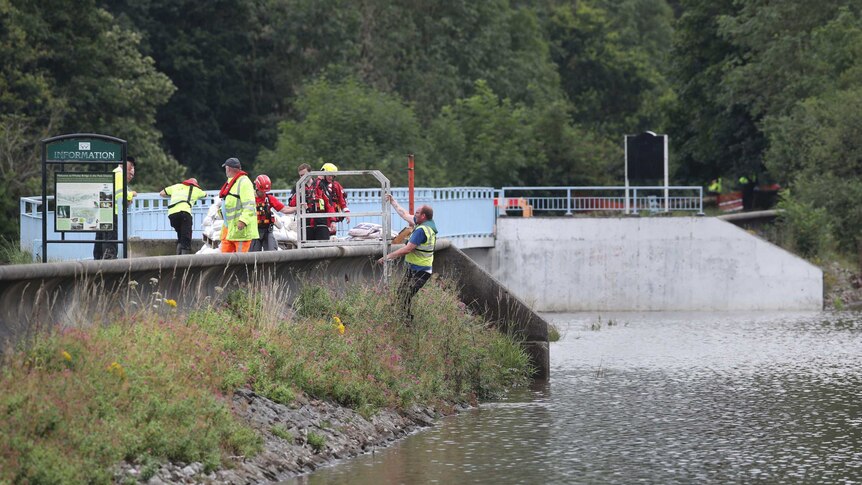 Emergency services inspect the reservoir.