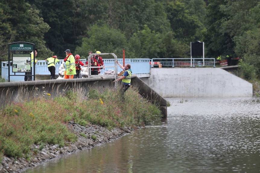 Emergency services inspect the reservoir.