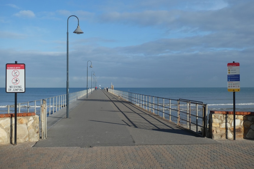 A jetty with no-one walking on it on a calm winter's day