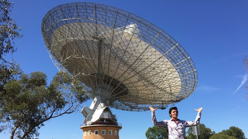 Elvis look-a-like under satellite dish