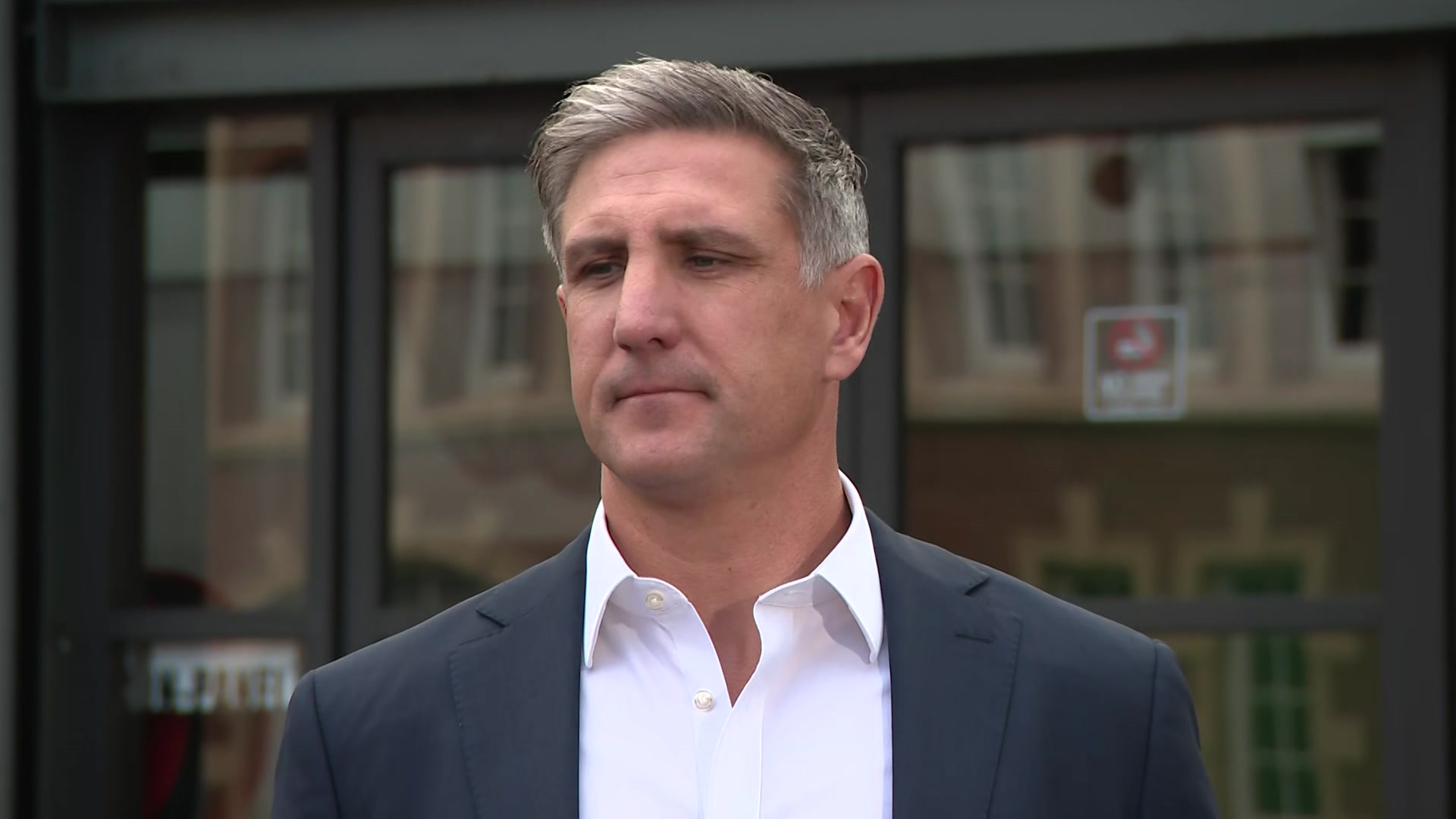 Matthew Pavlich, a man with silver hair in a blue blazer and white collared shirt.