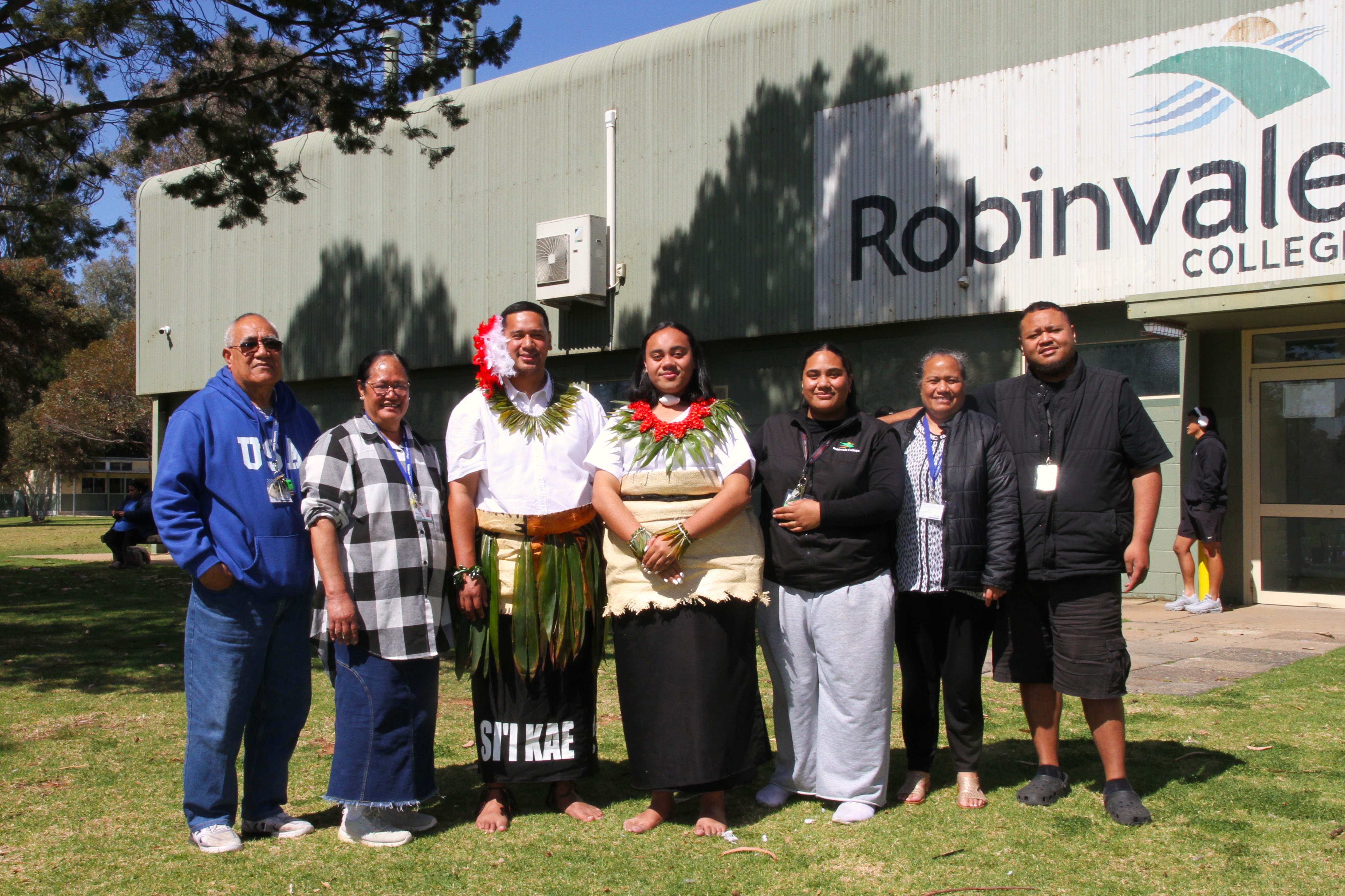 Seven Robinvale College staff pose in front of the Robinvale College gymnasium.