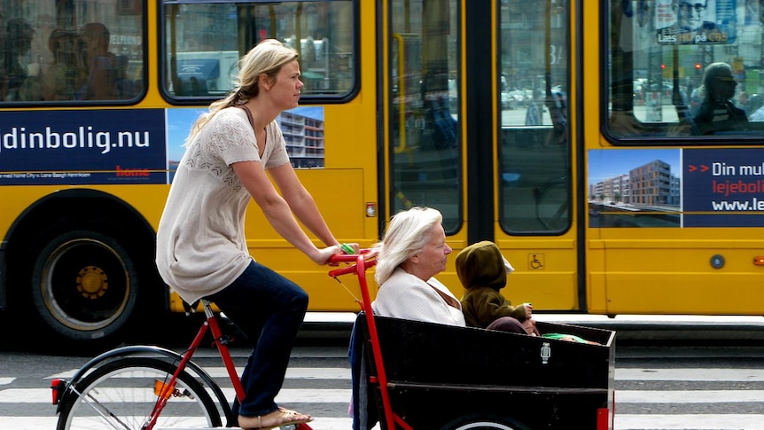 Three generations ride a cargo bike in Copenhagen.