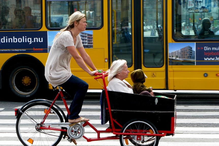 Three generations ride a cargo bike in Copenhagen.