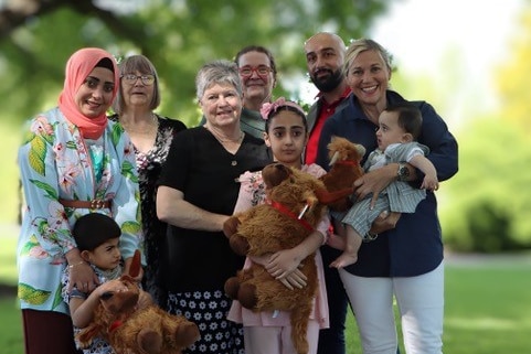 A group shot of a family in a park setting