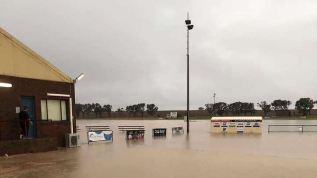 Flooded streets and footy ovals as slow-moving storm drenches SA's west coast