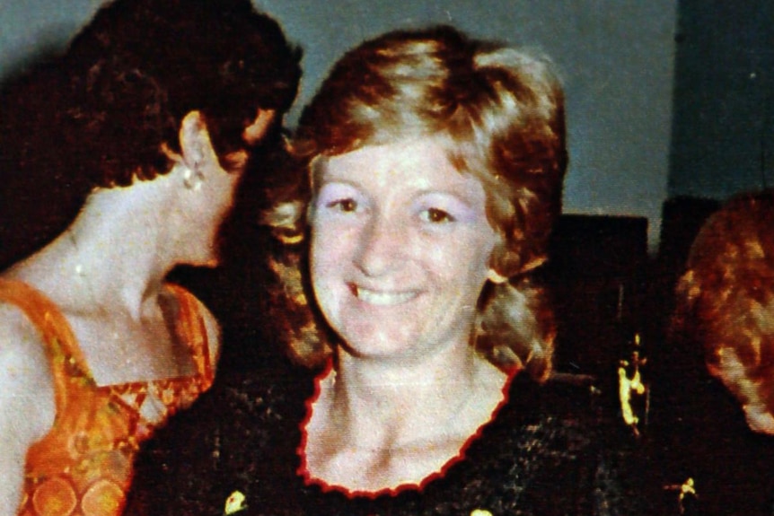 A dated image of a happy smiling woman. 