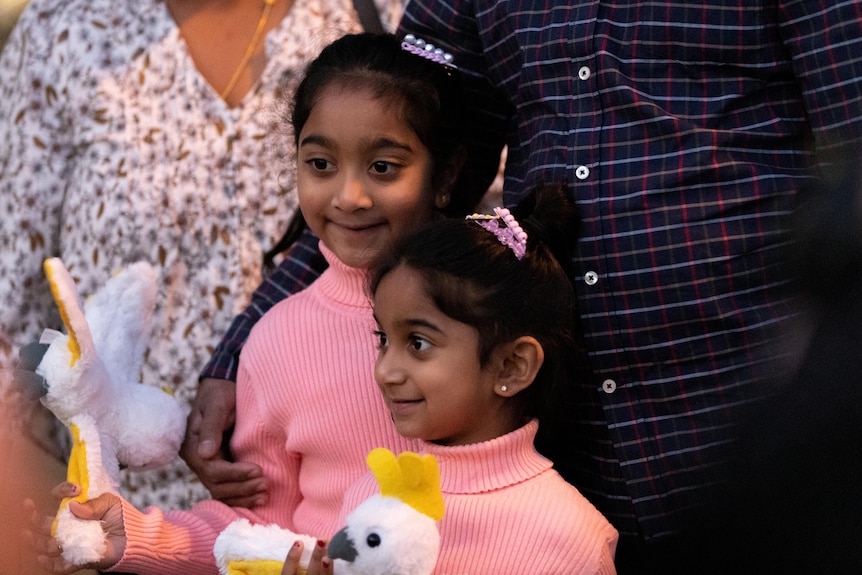 The Nadesalingam family stand together for a photo at Perth Airport.