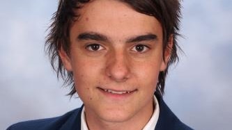 A young man poses for a school photo