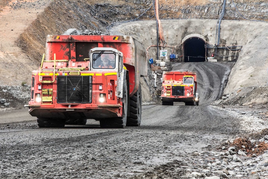 Mining trucks at the entrance to an underground mine.