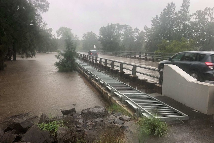 A bursting riverbank with a bridge going over it