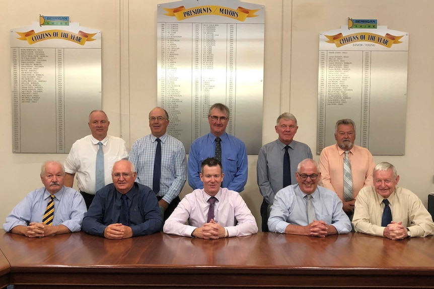 A group of men pictured in a board room.