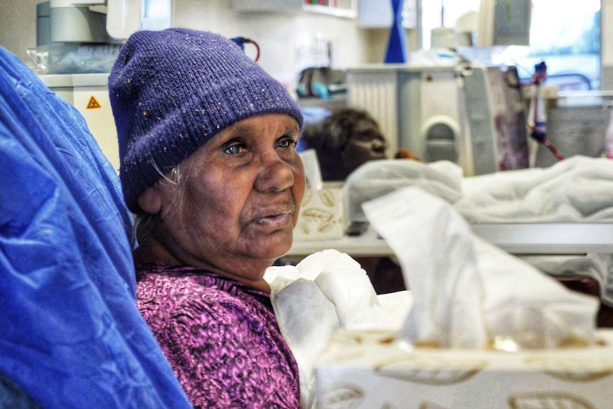 Mavis Holmes sits in a chair undergoing dialysis treatment.