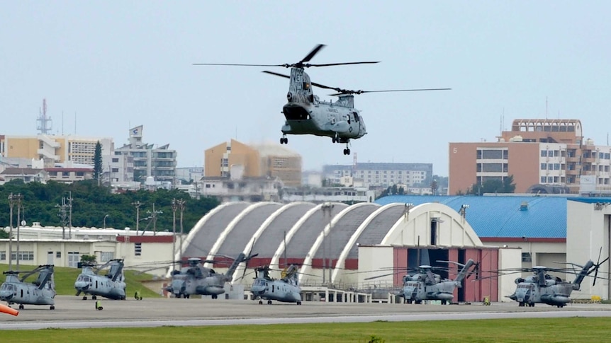 Helicopter comes in to land at the US Futenma military base